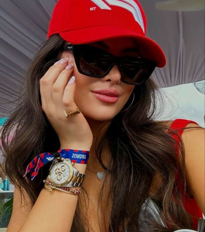 a woman in a red hat and sunglasses