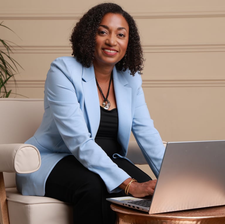 Beverly Vanterpool., sitting at a table with a laptop, Building her Table