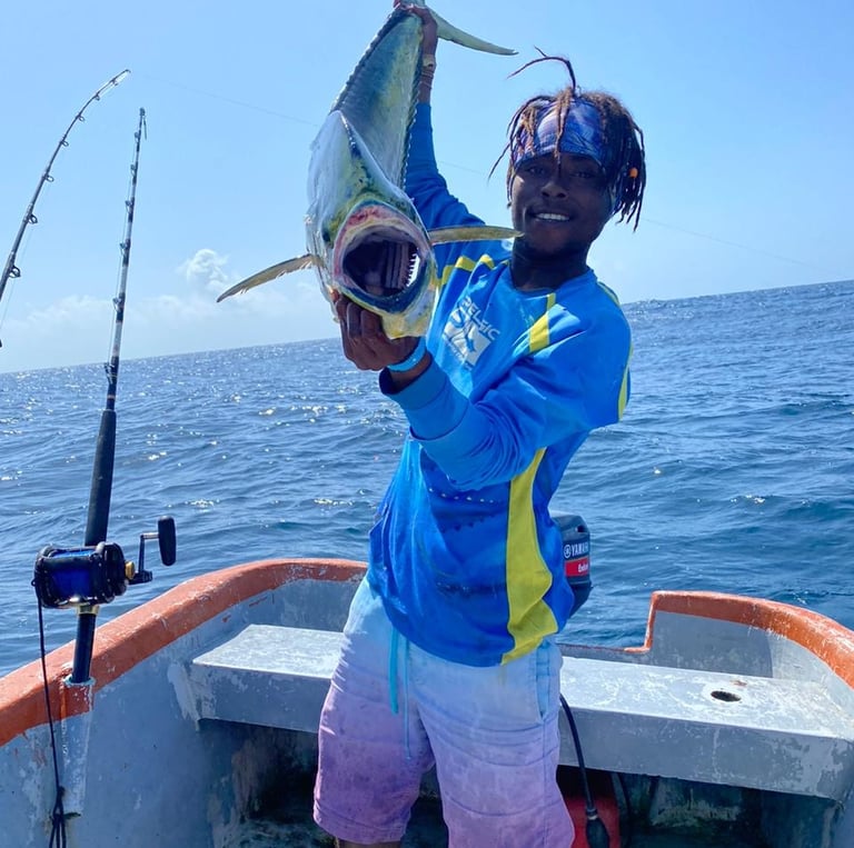 a man holding a fish on a boat