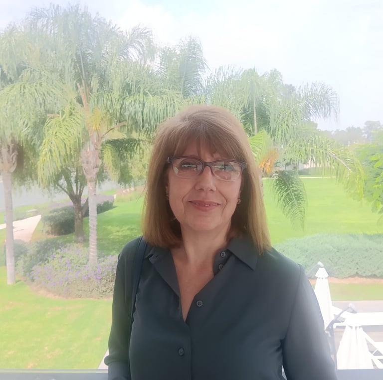 a woman in a blue shirt and glasses