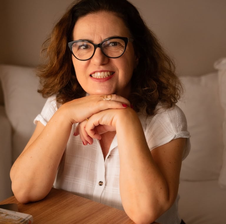 a woman sitting at a table with a laptop