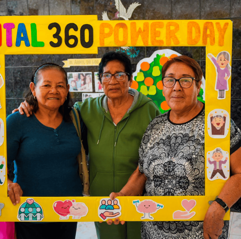 a woman in a blue shirt is holding a piece of paper