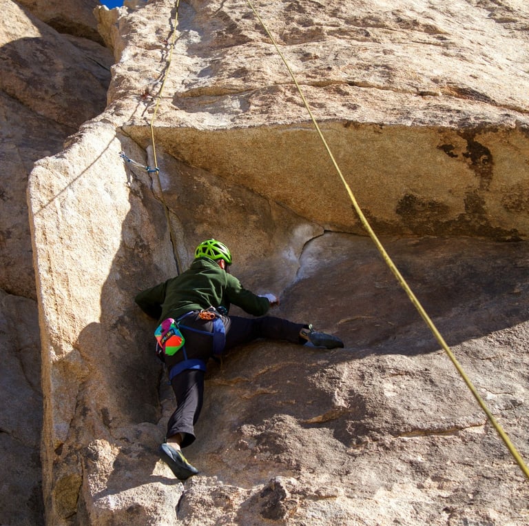 a person climbing a rock face on a rock face