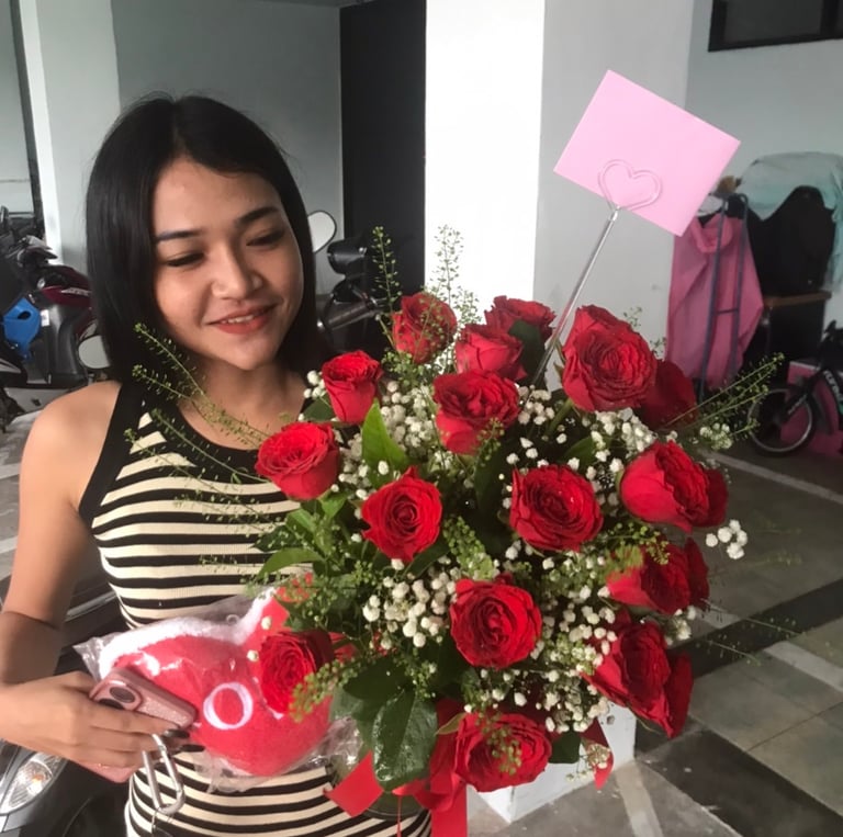 a woman holding a bouquet of roses in her hands