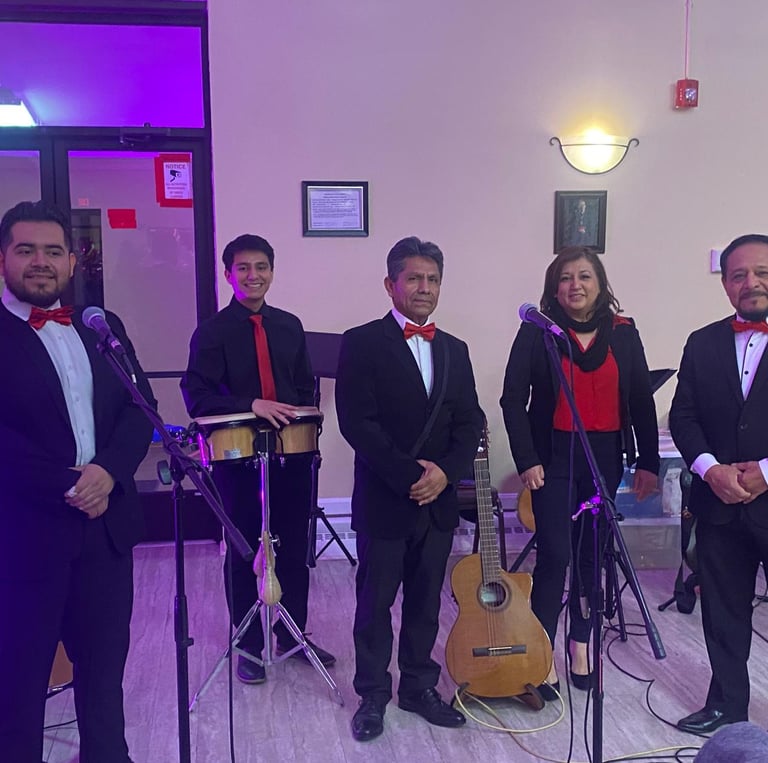 Live music band group taking a photo with guitars and bongos in the background.