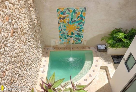 a pool with a fountain and a fountain