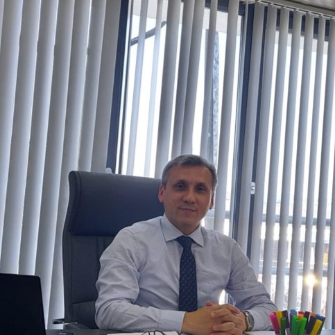 a man in a suit and tie sitting at a desk