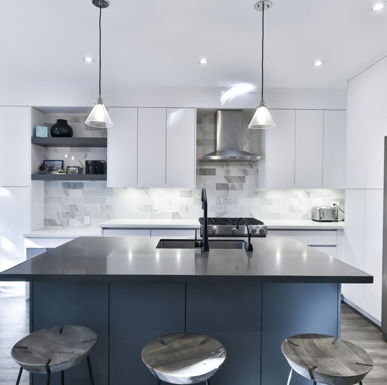 a kitchen with a stainless steel refrigerator and a large island