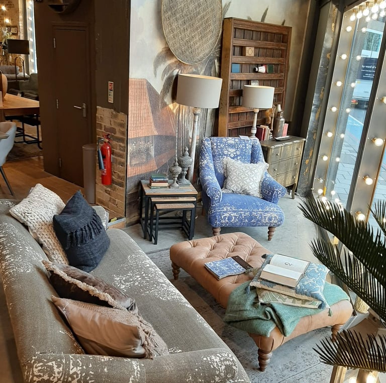 a living room with a sofa a armchair a wall mural and accessories