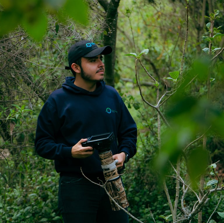 a man in a black hat and a camera