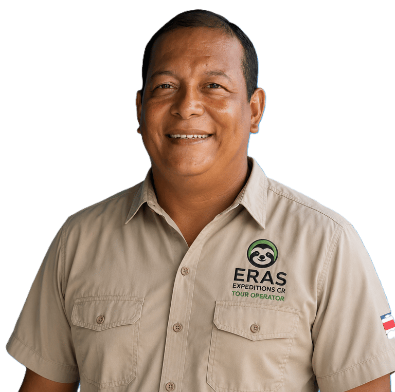Smiling male tour guide wearing a tan Eras Expeditions CR uniform shirt against a black background.