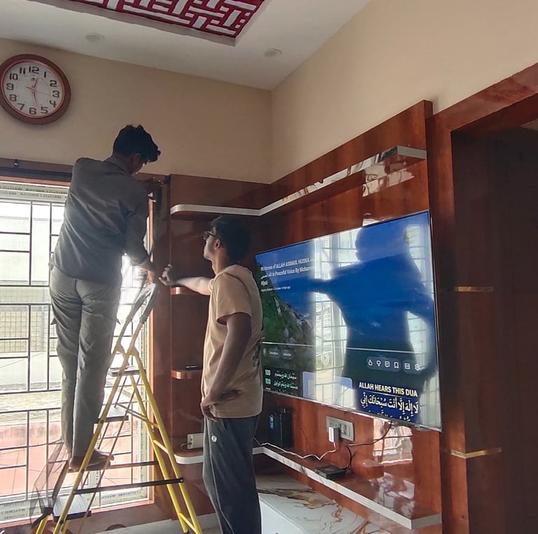 A technician fitting a velcro mosquito net on a sunny Bangalore balcony.