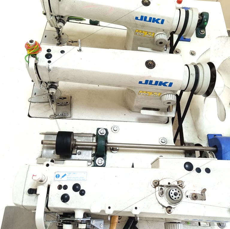 Triple head industrial human hair sewing machine used for manufacturing human hair wefts at Tanori Hair LLP in India.