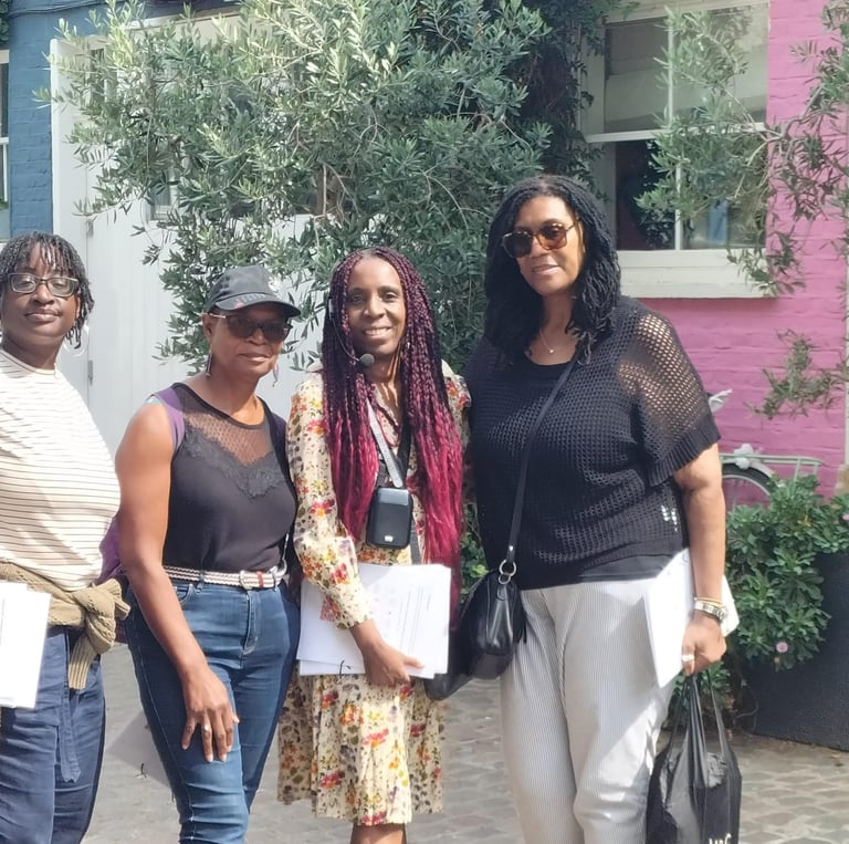 a group of people standing in front of the Love Actually house in Notting Hill
