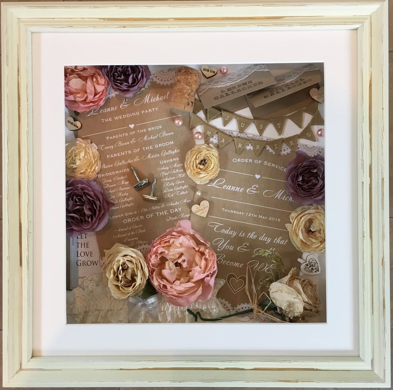 memory box full of wedding items, cufflinks preserved flowers and invites