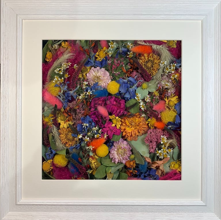 a beautiful bright flower wall style preserved wedding bouquet in a frame