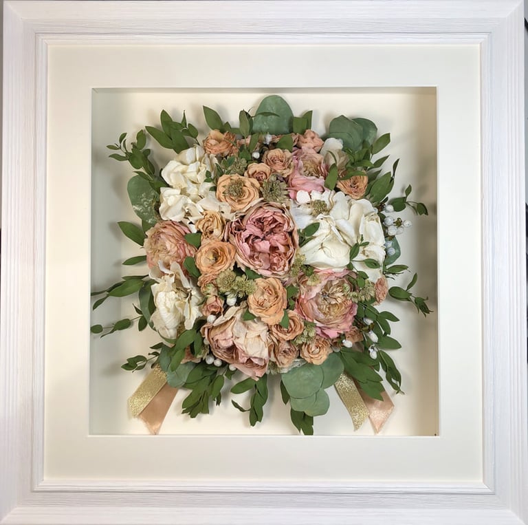 Birdseye view preserved wedding bouquet with ribbons and foliage in a frame