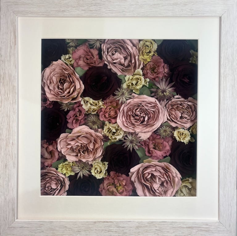 a pink and deep red flower wall style preserved wedding bouquet in a frame