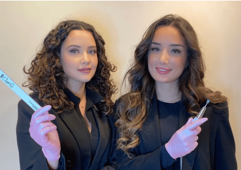 two women in suits and gloves holding toothbrushes