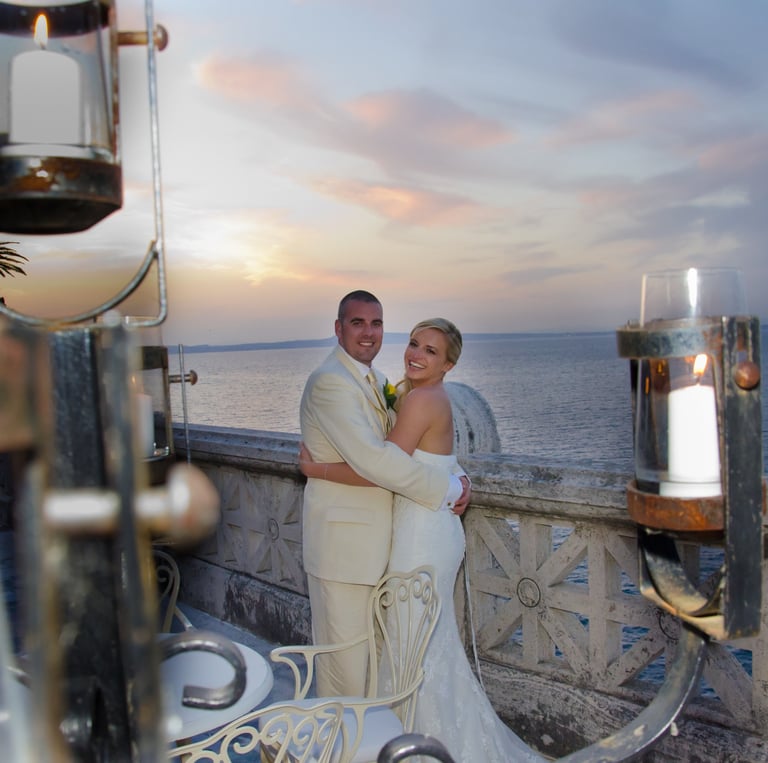 newly weds smiling in front of sunset