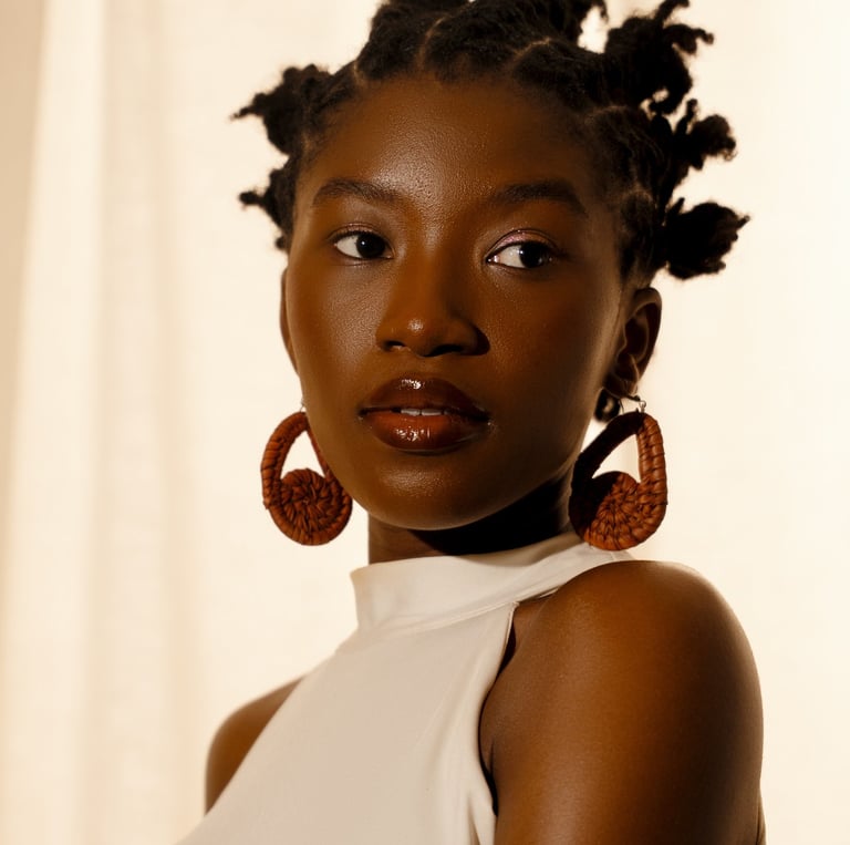"Close-up headshot of a Nigerian spoken word poet and actor looking intensely at the camera.