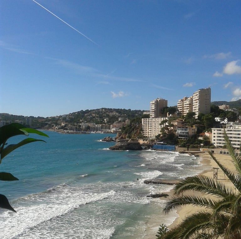 Cala Mayor coastline with a few high rise buildings in background which lies just West of Palma City