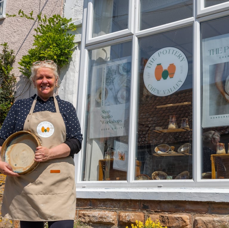a woman in a apron and aprons holding a tray with a tray of food