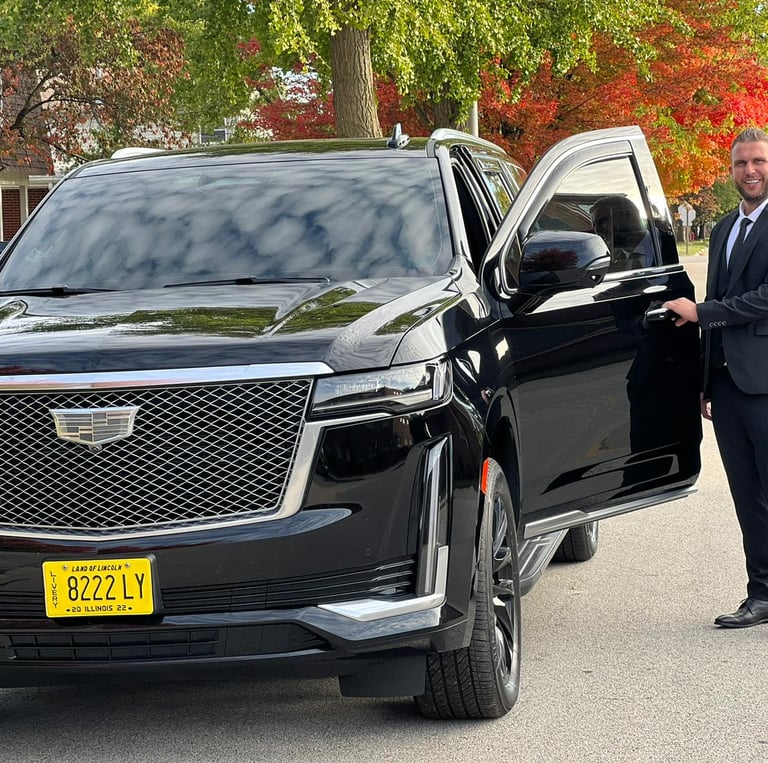 A chauffeur standing next to an SUV