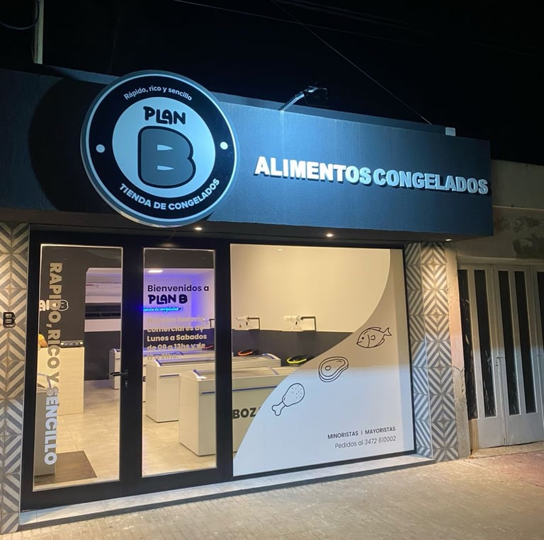 a business sign on a building with a phone in front of it