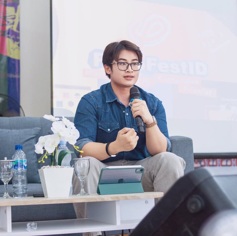 a man in a blue shirt is holding a microphone