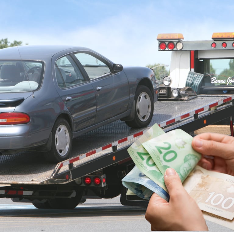 a person holding Canadian dollar bills in front of a junk car on a flatbed