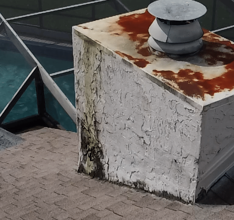 Severe stucco failure and water damage on New Port Richey Florida chimney before repair