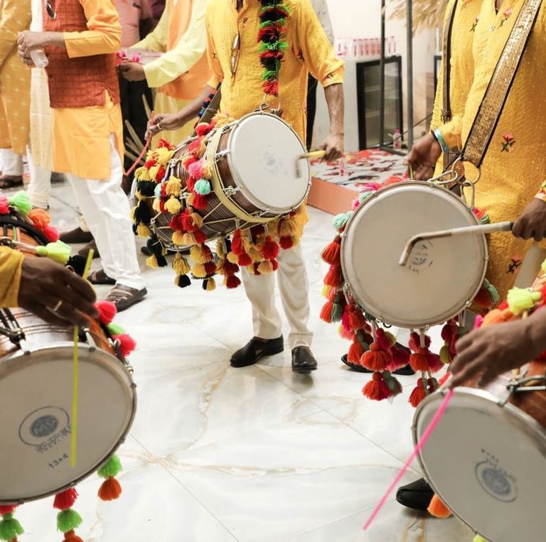 a group of men in traditional indian garb playing drums