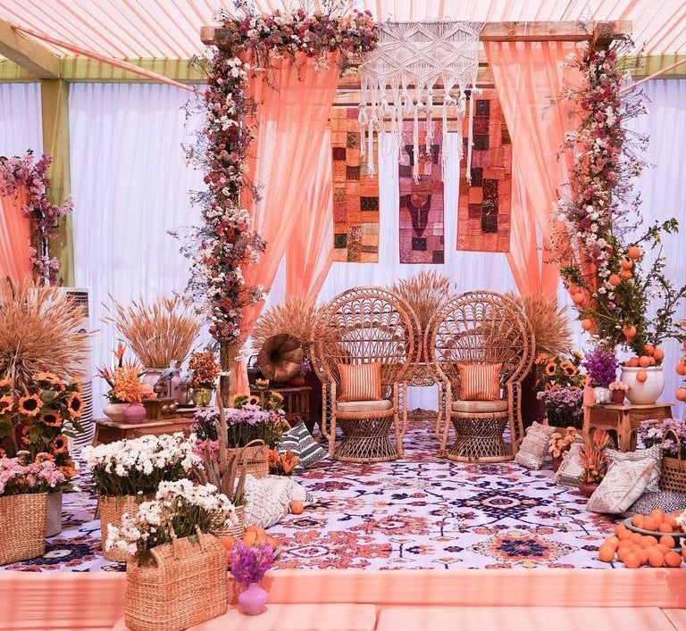 a wedding ceremony with a floral arrangement of flowers and flowers