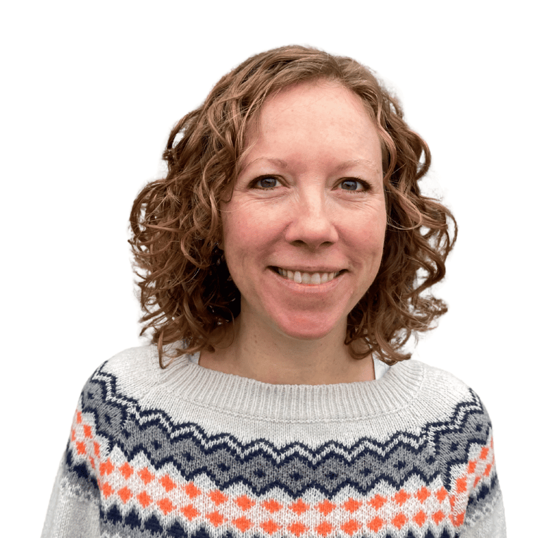 photo of Iona Reading, Health Coach. Iona is wearing a grey jumper with a blue and orange pattern.