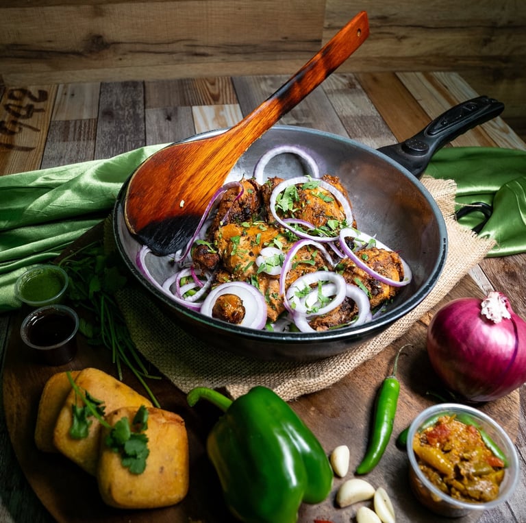 Delicious Indian food, with samosas, tandoori chicken, and curry.