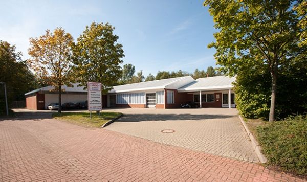a building with a brick building and trees