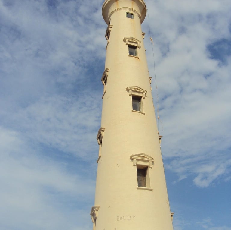 a lighthouse with a clock tower in the background