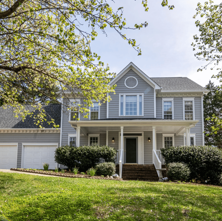 a house with a large front yard and a driveway