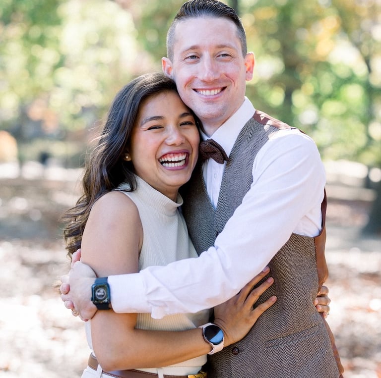 a man and woman are smiling and hugging