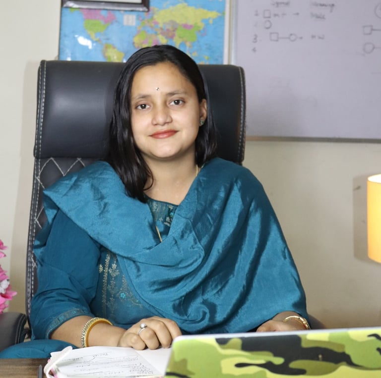 a woman sitting at a desk with a laptop computer