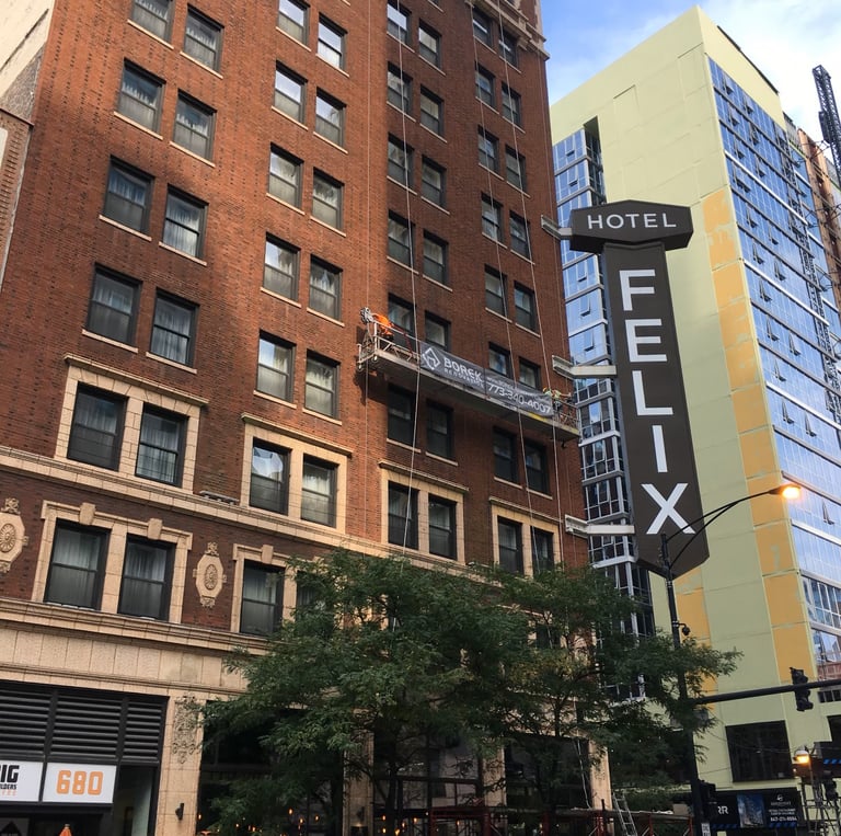 Facade restoration of the high-rise Hotel Felix building using suspended scaffolding.