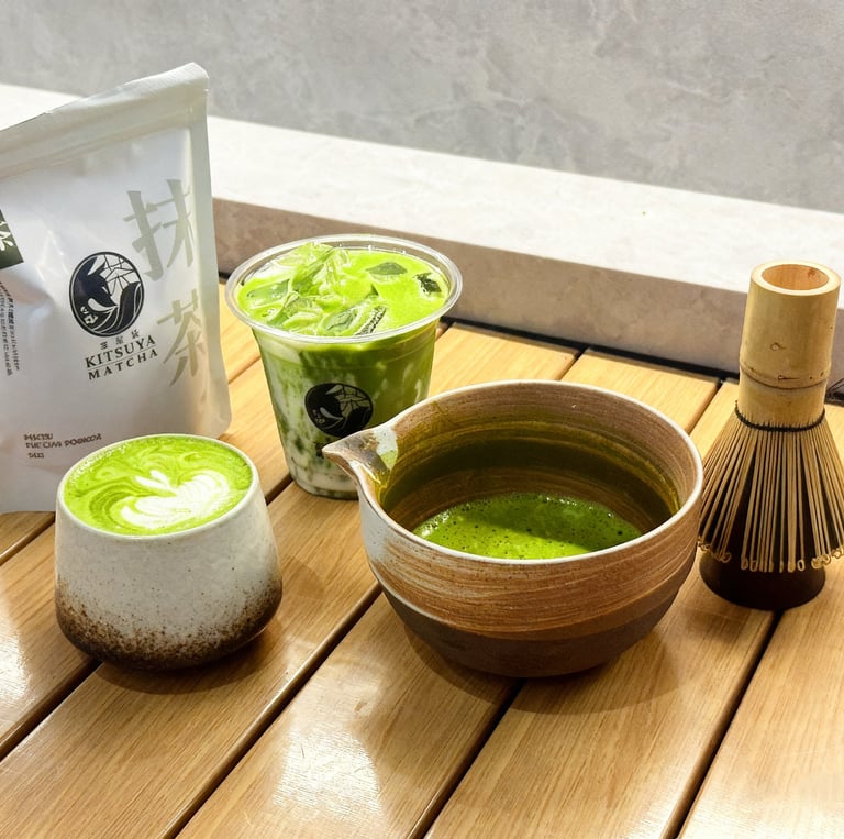 Iced and hot Cafe Kitsune matcha green tea lattes with bamboo whisk and ceramic bowl.