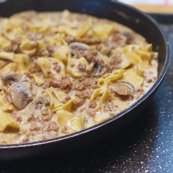 ground beef stroganoff in black pan with mushrooms