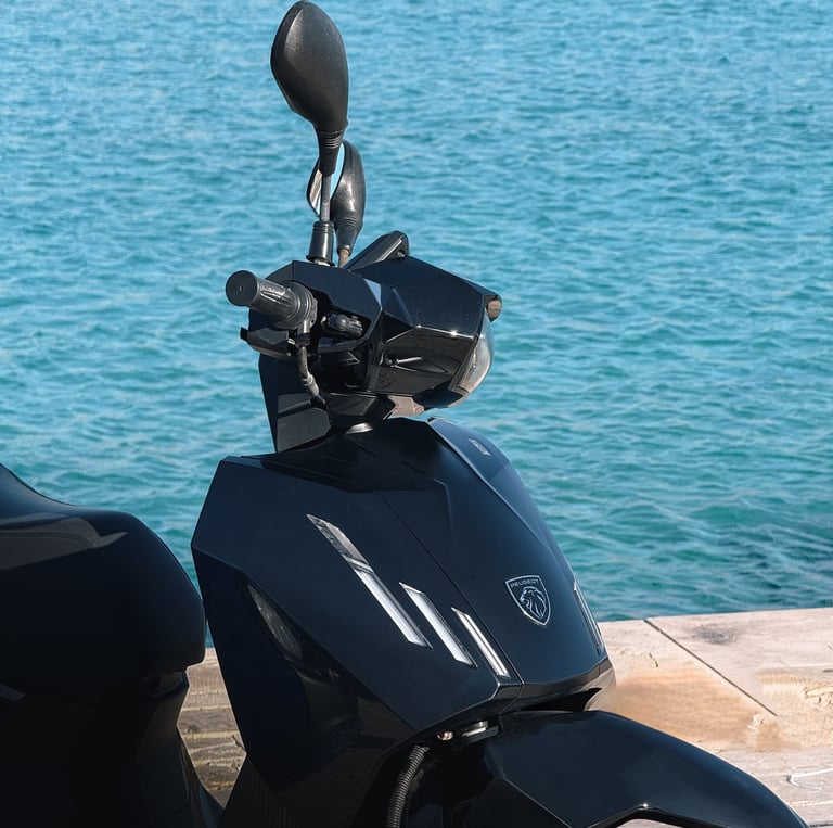 a motorcycle parked on a wooden deck near the water