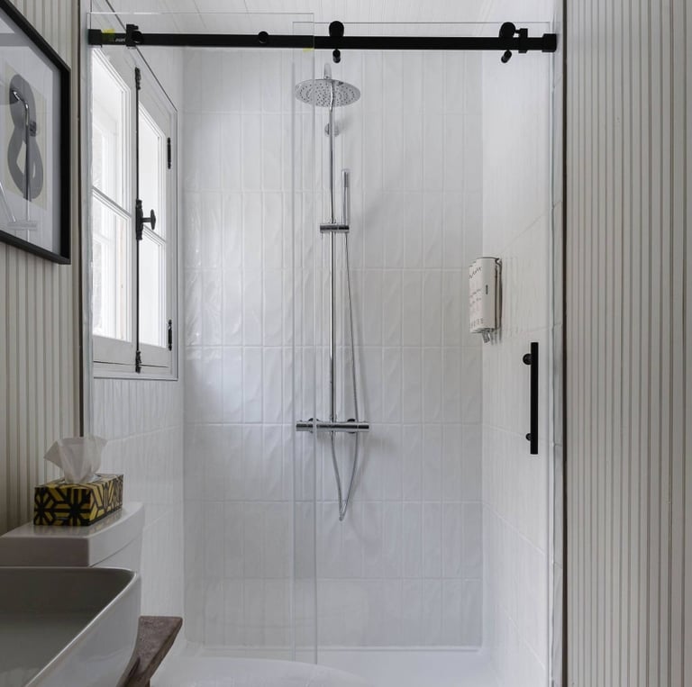 a bathroom with a toilet and a shower