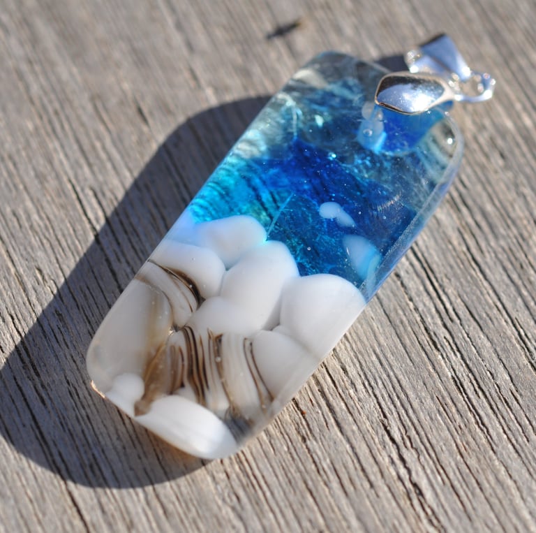 a blue and white fused glass pendant