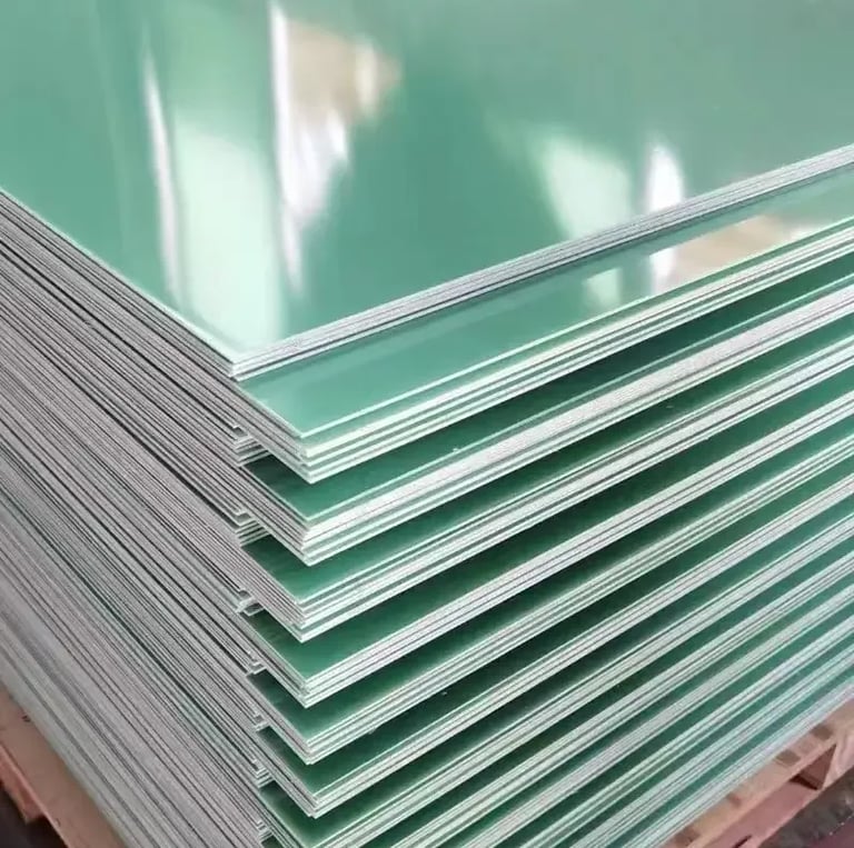 Stack of green epoxy resin fiberglass FR4 sheets on a wooden pallet for industrial insulation.