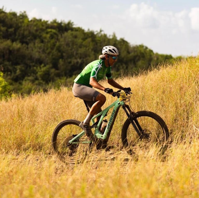 a man riding a bike through a field