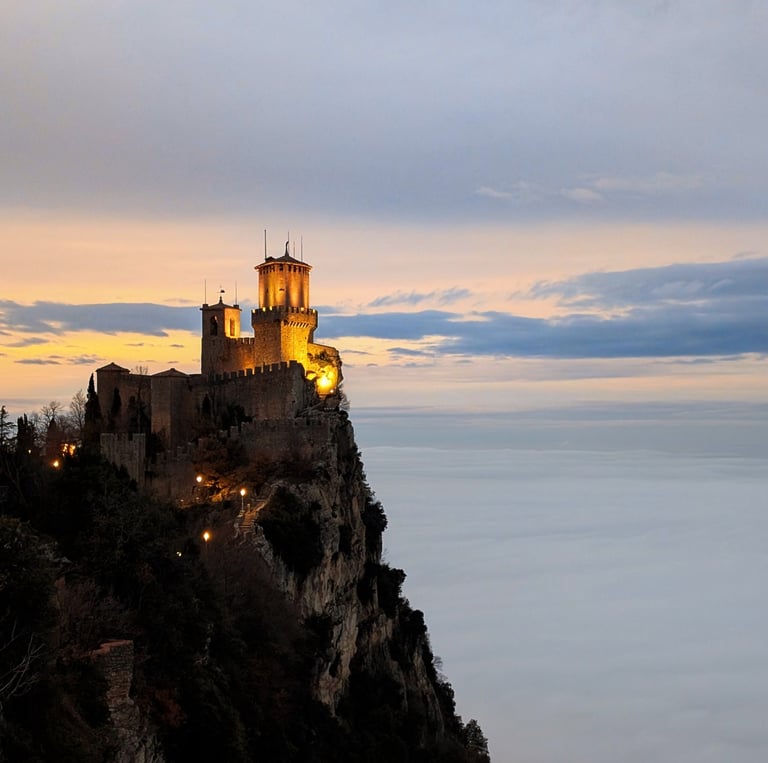 One of San Marino's towers overlooking clouds at sunset